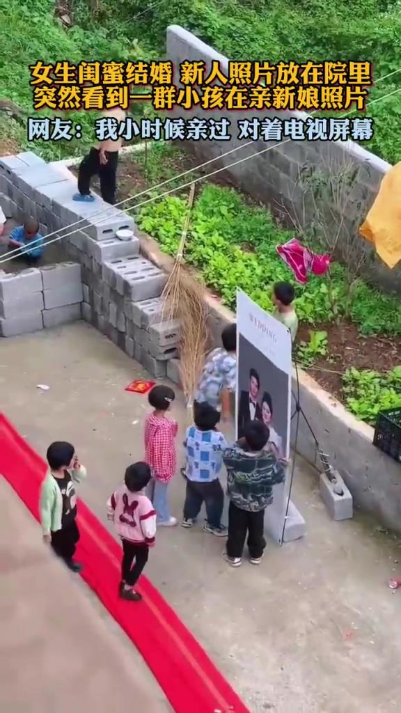 女生閨蜜結婚新人照片放在院里,突然看到一群小孩在親新娘照片！