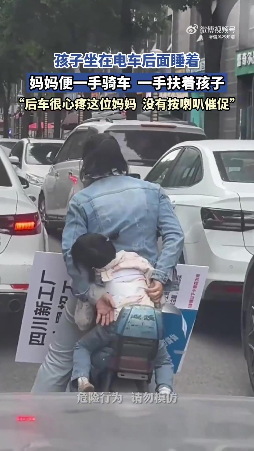 媽媽騎電車時一手扶睡著的孩子，單手操控令人捏把汗