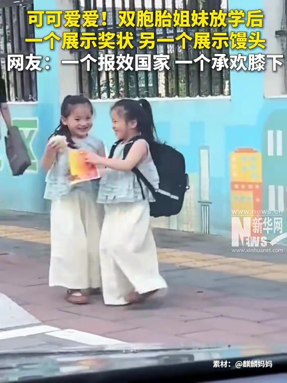 可可愛愛！雙胞胎姐妹放學(xué)后，一個展示獎狀，另一個展示饅頭。